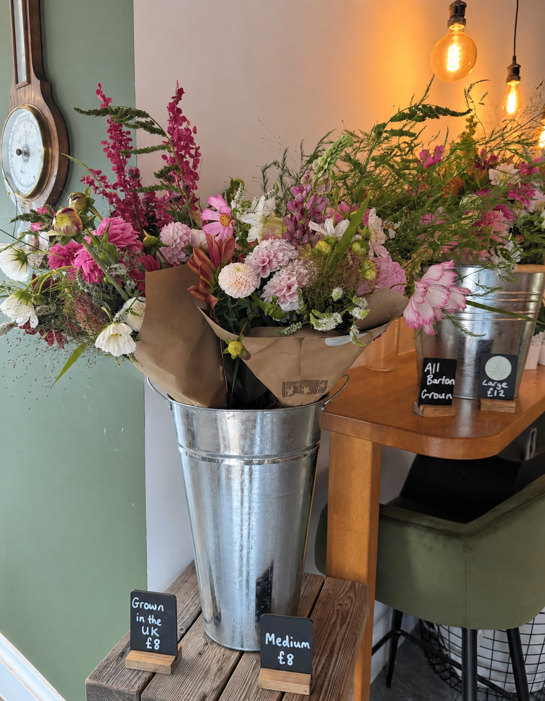 Buckets of freshly cut dahlias and seasonal British flowers in the farm shop