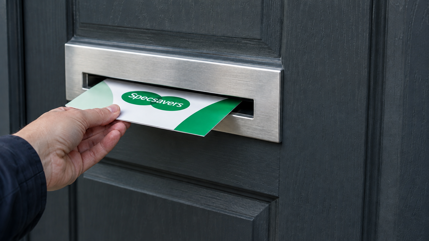 A Specsavers leaflet being posted through the letterbox of a British home