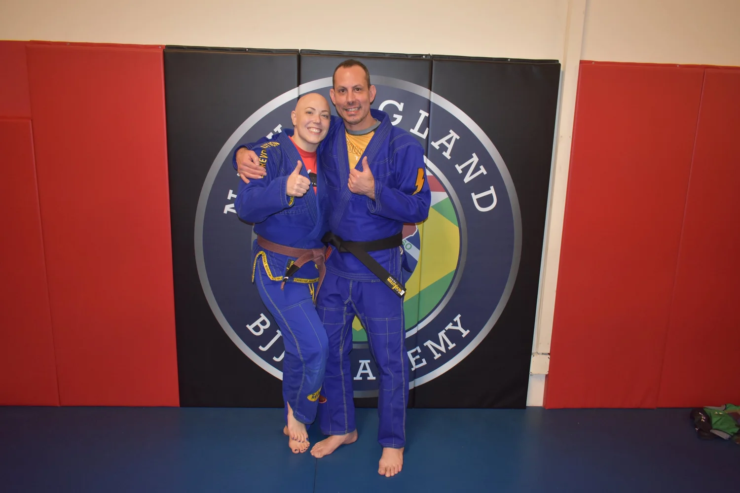 Students working together during class on the mats