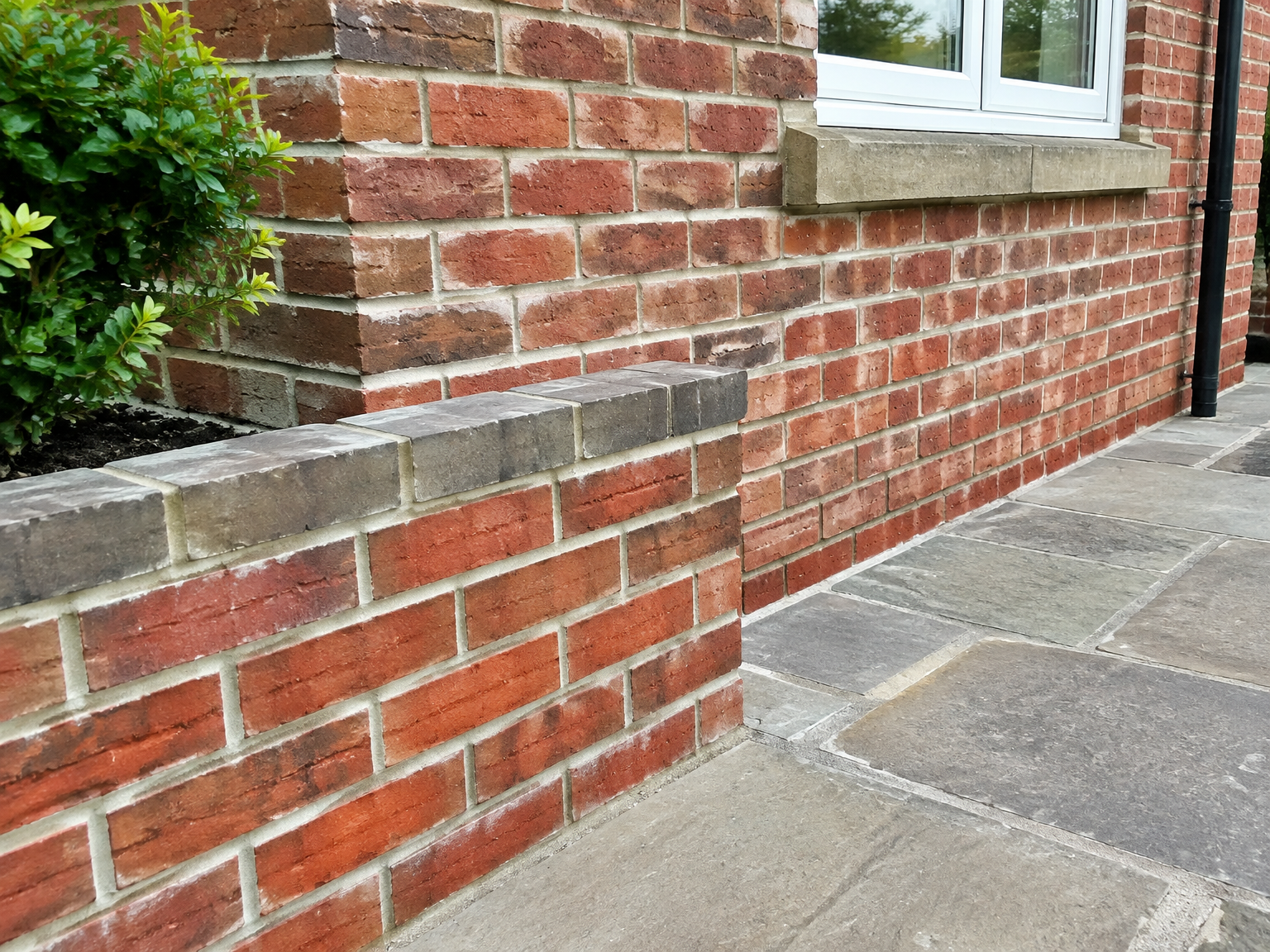 Crisp fresh pointing on a red brick house wall and garden wall