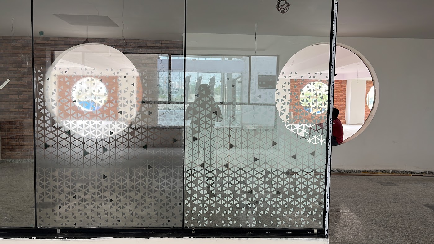 Frosted one-way vision film with a geometric cut pattern on glass partitions