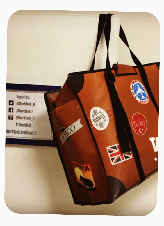 WISSHH Travel Bag in the vintage orange travel-stickers edition, shown at SharkTank Italia by Mediaset