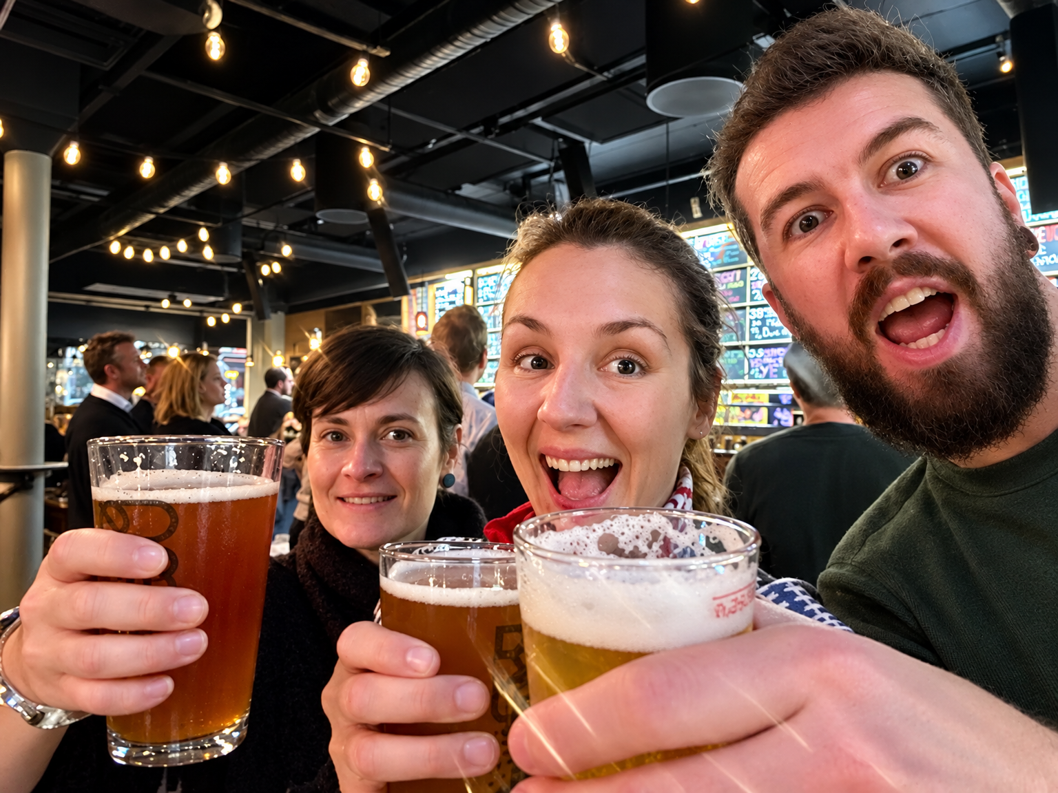 Happy OsloWay tour guests toasting with glasses of beer in a lively Oslo beer hall