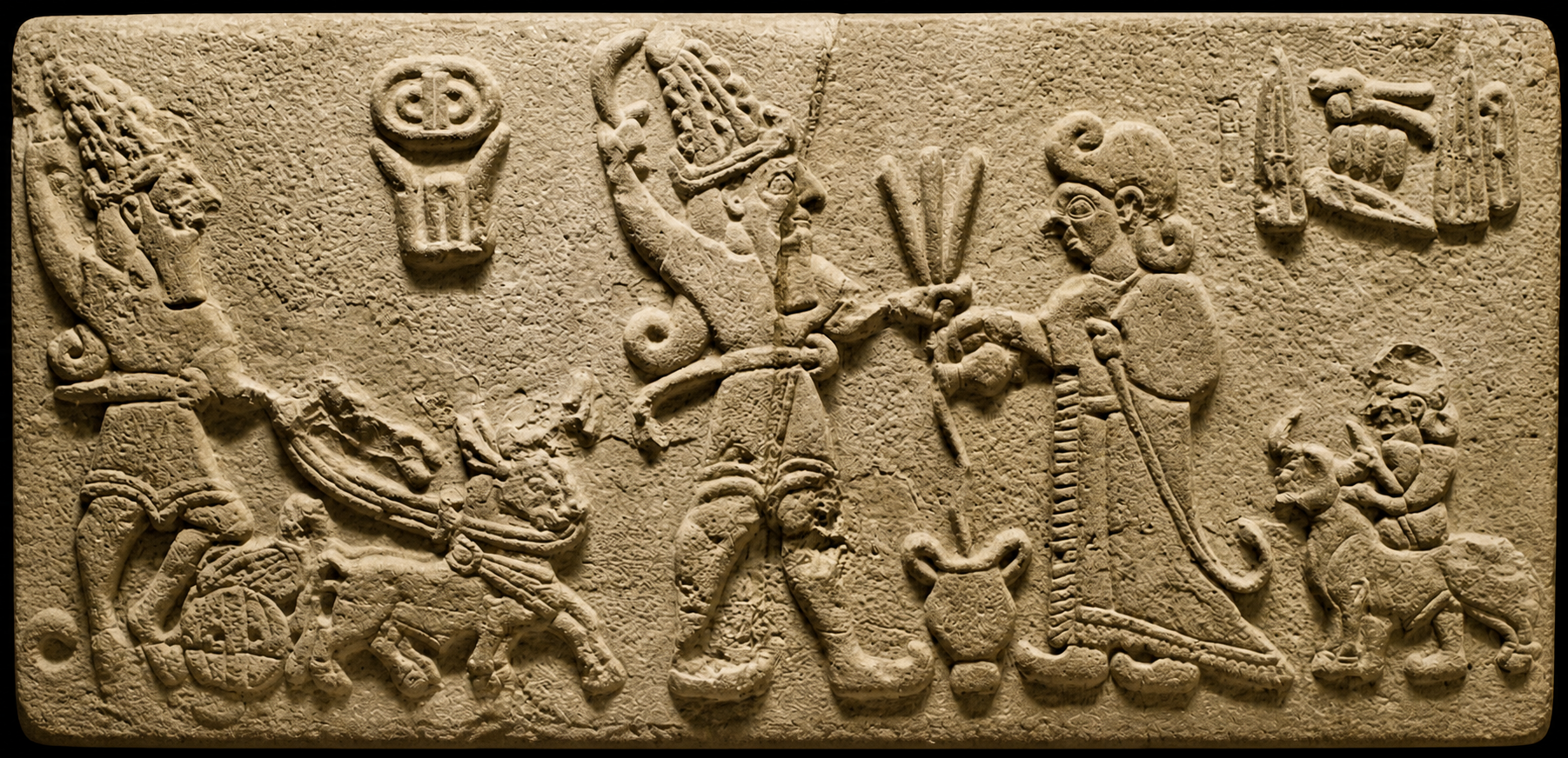 Storm-god stela carved on a basalt orthostat from Arslantepe, dated 1200–700 BC, showing a bearded deity with horned headdress holding weapons