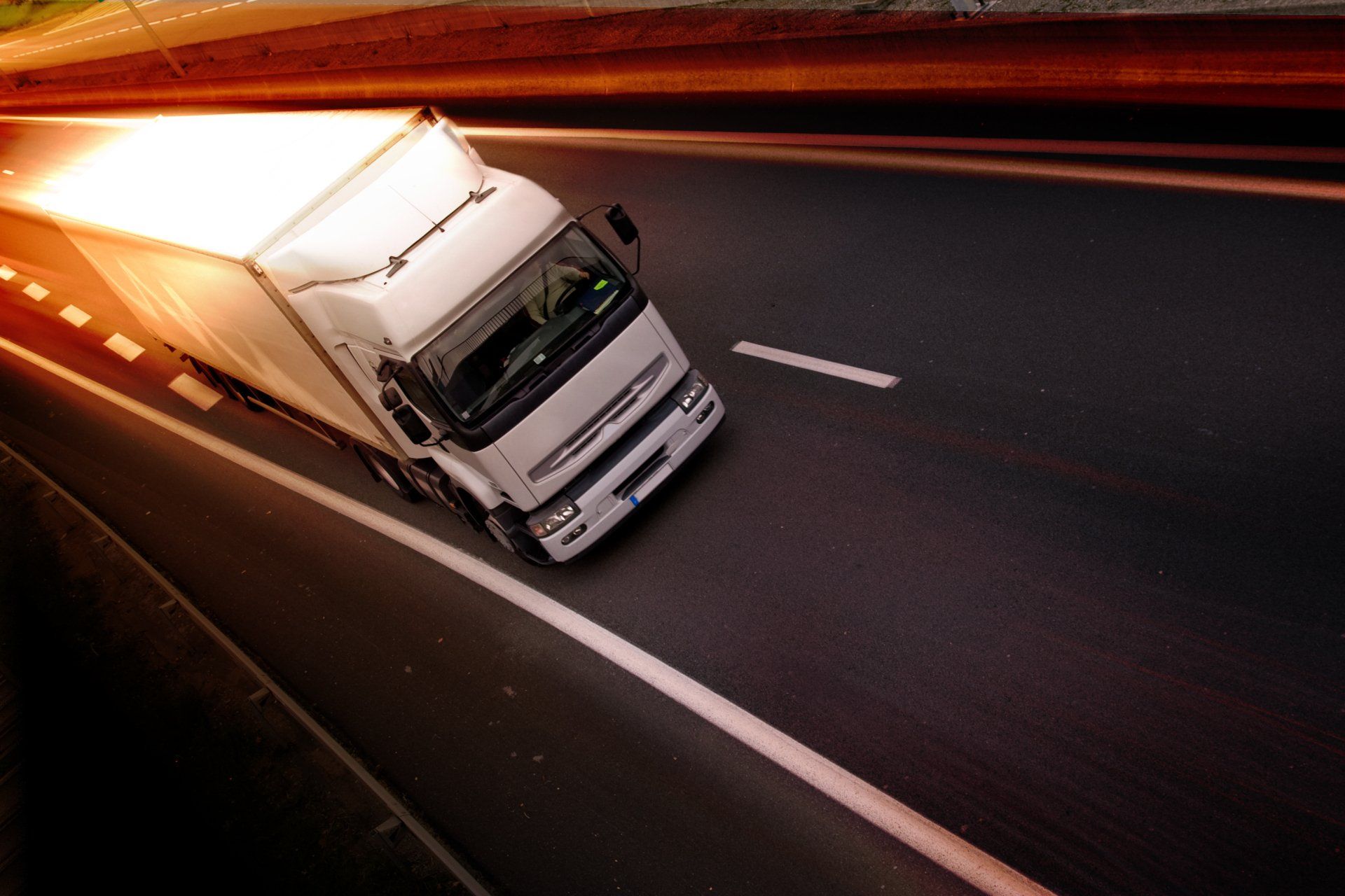 Freight lorry on a motorway at dusk