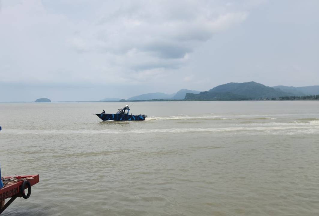 A Marine Police boat speeding across the channel off Kuala Perlis
