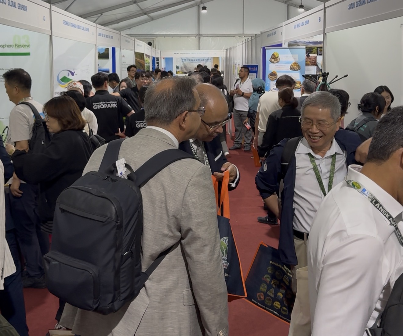 Delegates from geopark networks around the world crowd the aisles of the Geopark Fair exhibition tents
