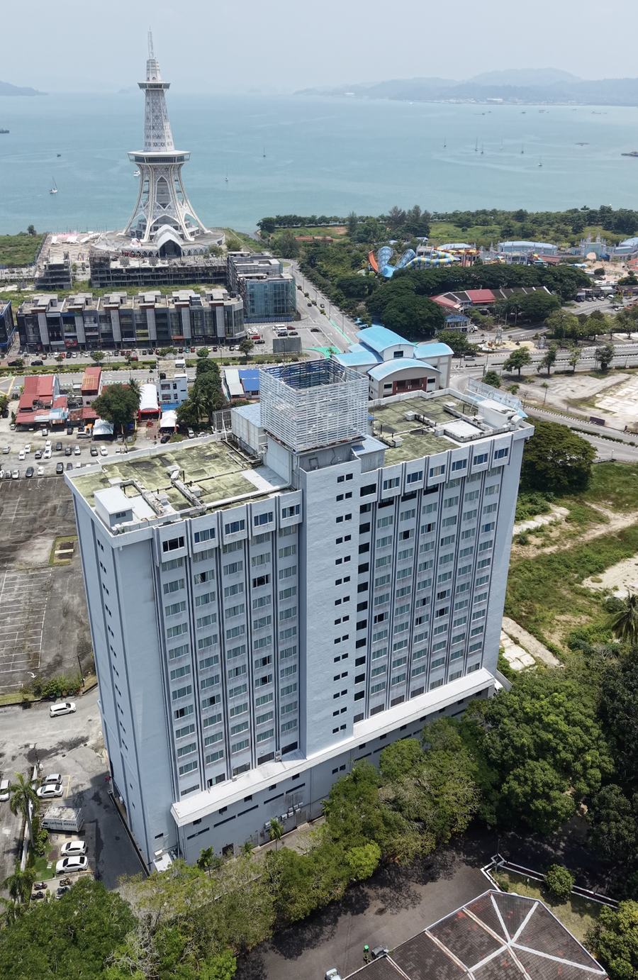 Aerial view of the Bayview Hotel Langkawi tower in Kuah, with the town's waterfront and Maha Tower visible in the distance