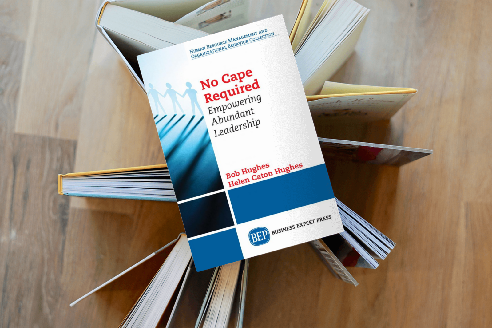 No Cape Required resting on a stack of open books