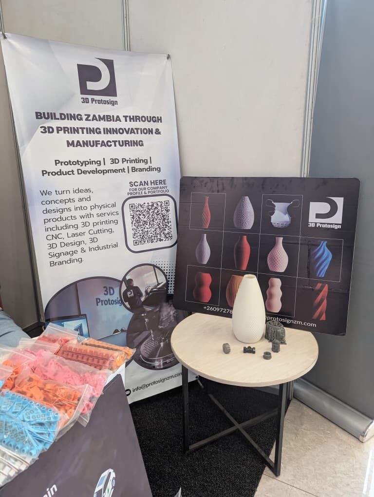 The Protosign expo stand with banner and vases