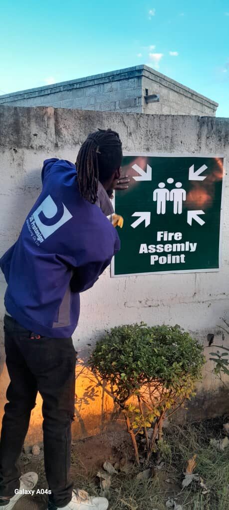 Installing fire assembly point safety signage